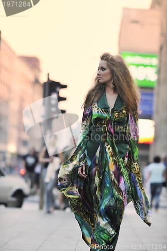 Image of elegant woman on city street at night