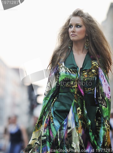 Image of elegant woman on city street at night