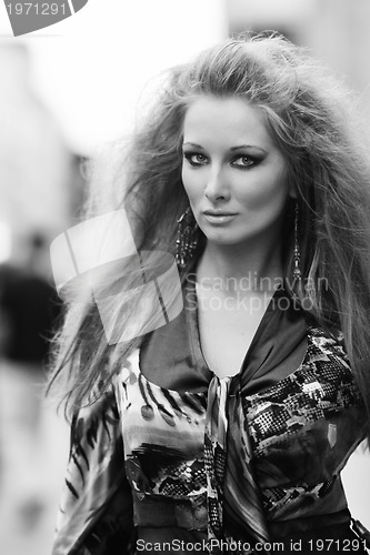 Image of elegant woman on city street at night