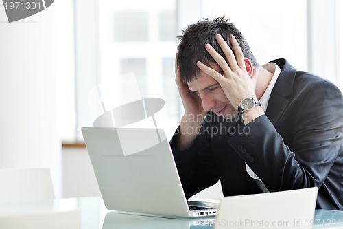 Image of young business man alone in conference room