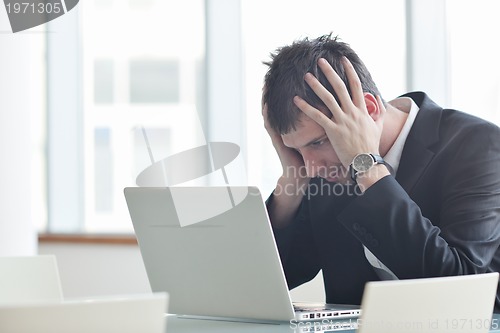 Image of young business man alone in conference room