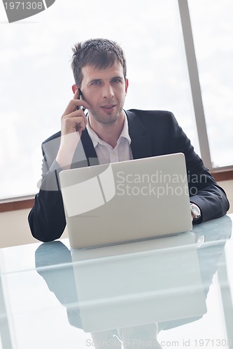 Image of young business man alone in conference room