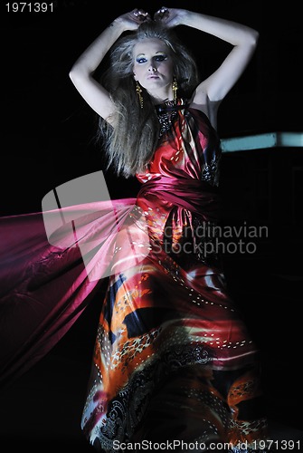 Image of elegant woman on city street at night