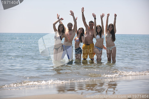 Image of happy people group have fun and running on beach