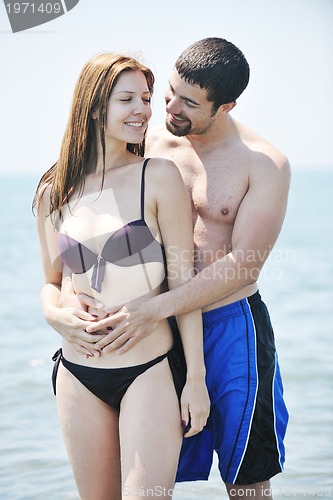 Image of happy young couple have romantic time on beach