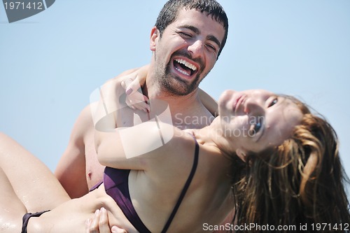 Image of happy young couple have romantic time on beach