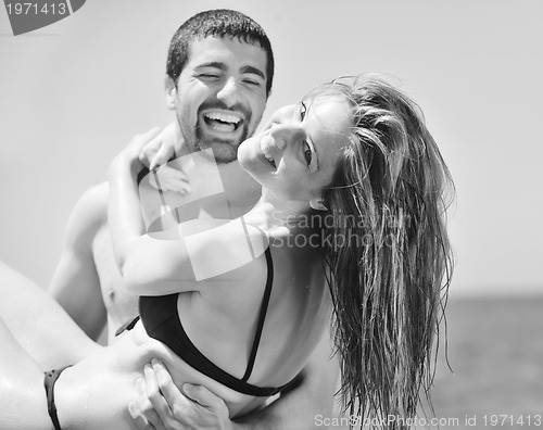 Image of happy young couple have romantic time on beach