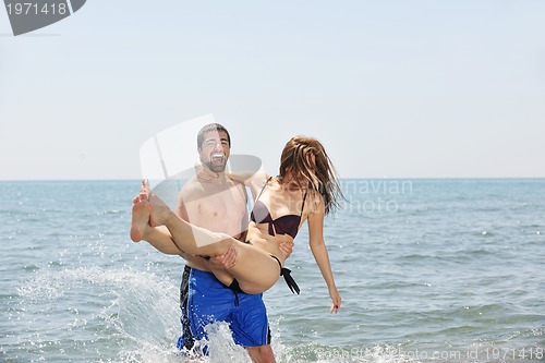 Image of happy young couple have fun on beach