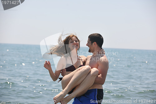 Image of happy young couple have fun on beach