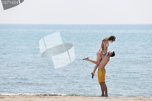 Image of happy young couple have fun on beach