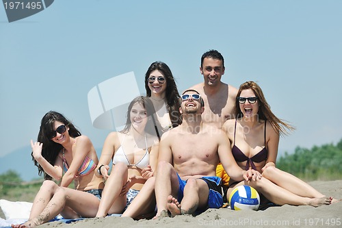 Image of Group of happy young people in have fun at beach