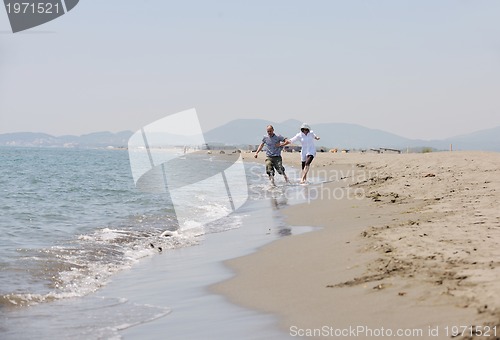 Image of happy young couple have fun on beach