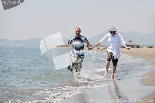 Image of happy young couple have fun on beach
