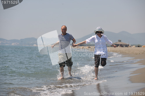 Image of happy young couple have fun on beach