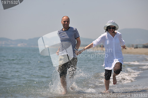 Image of happy young couple have fun on beach