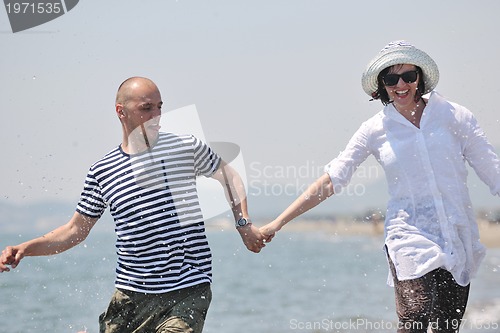 Image of happy young couple have romantic time on beach