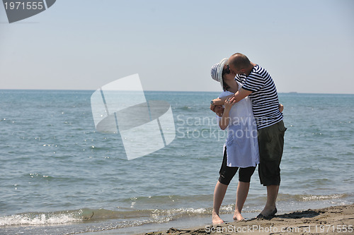 Image of happy young couple have fun on beach
