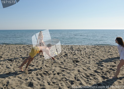 Image of young people group have fun and play beach volleyball