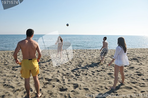 Image of young people group have fun and play beach volleyball