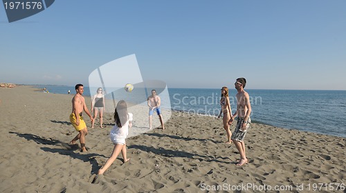 Image of young people group have fun and play beach volleyball