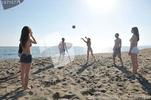 Image of young people group have fun and play beach volleyball