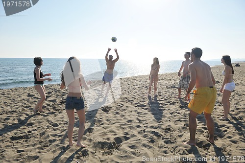 Image of young people group have fun and play beach volleyball