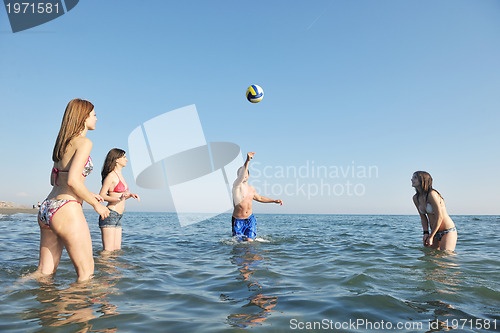 Image of young people group have fun and play beach volleyball