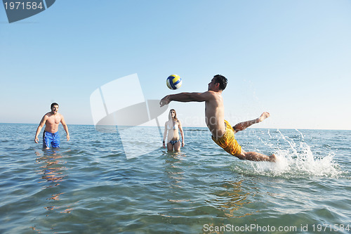 Image of young people group have fun and play beach volleyball