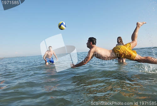 Image of young people group have fun and play beach volleyball