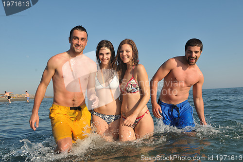 Image of happy people group have fun and running on beach