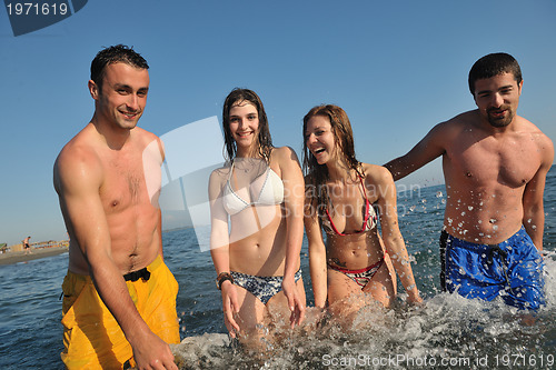 Image of happy people group have fun and running on beach