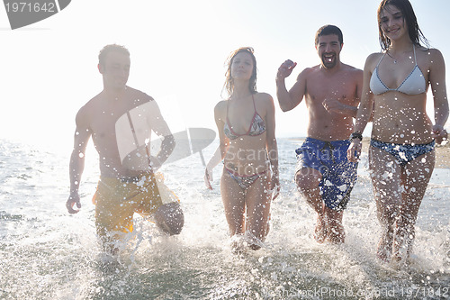 Image of happy people group have fun and running on beach