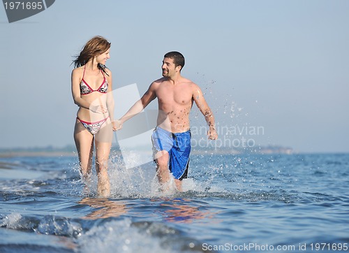 Image of happy young couple have romantic time on beach