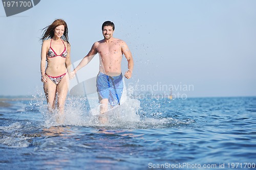 Image of happy young couple have romantic time on beach