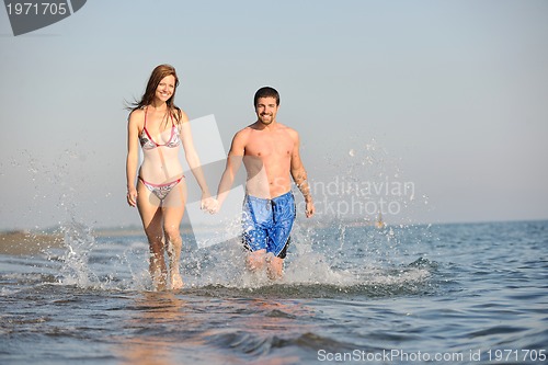 Image of happy young couple have fun on beach