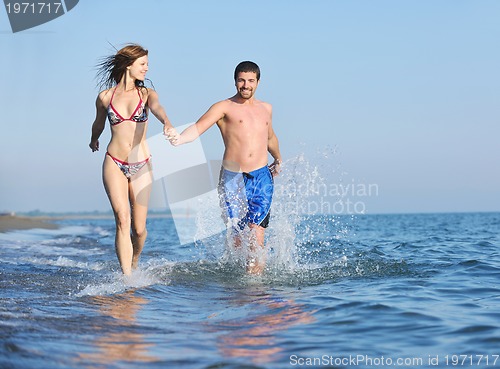 Image of happy young couple have romantic time on beach