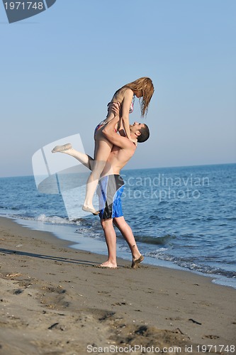 Image of happy young couple have romantic time on beach