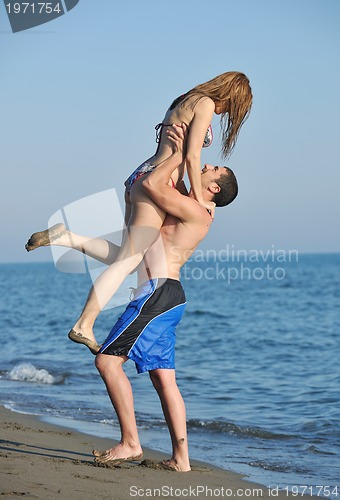 Image of happy young couple have romantic time on beach