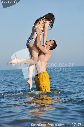 Image of happy young couple have romantic time on beach