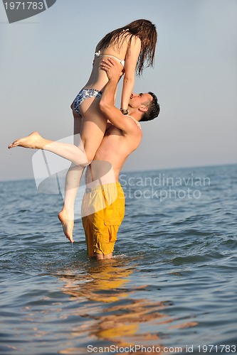 Image of happy young couple have fun on beach