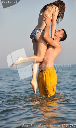 Image of happy young couple have fun on beach