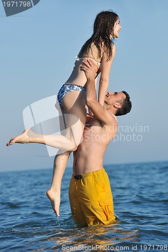 Image of happy young couple have romantic time on beach