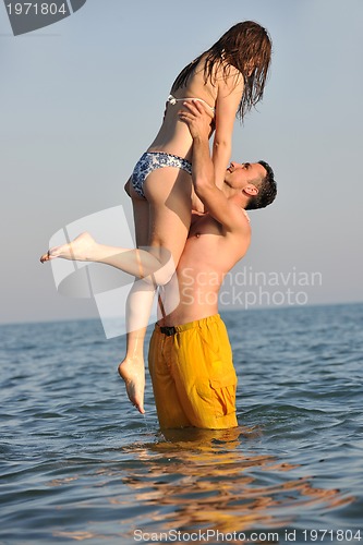Image of happy young couple have fun on beach