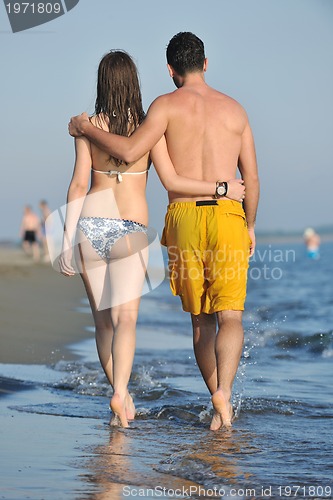 Image of happy young couple have romantic time on beach