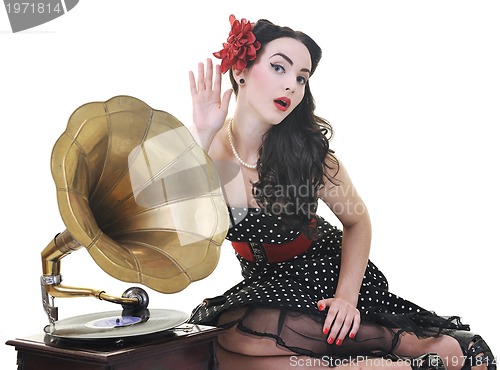 Image of pretty girl listening music on old gramophone