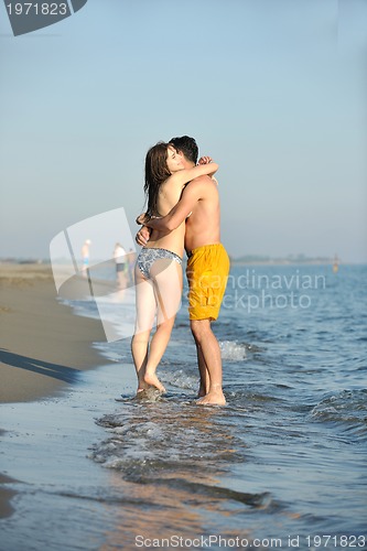 Image of happy young couple have fun on beach