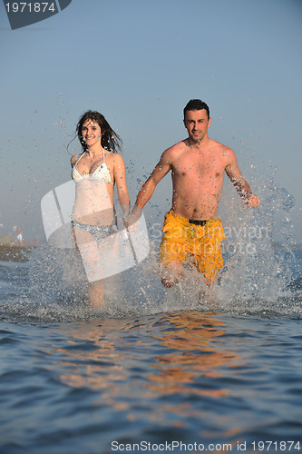 Image of happy young couple have fun on beach