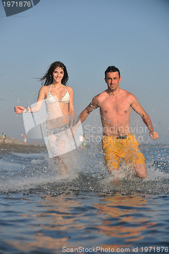 Image of happy young couple have fun on beach