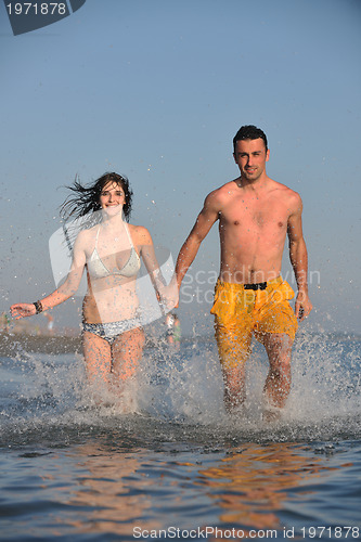 Image of happy young couple have fun on beach