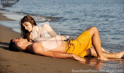 Image of happy young couple have fun on beach